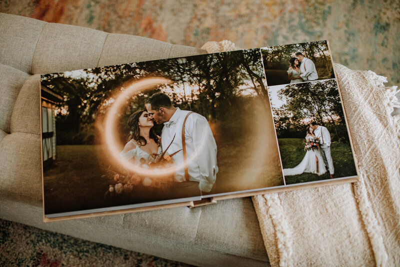 Open photo album with wedding couple pictures in it