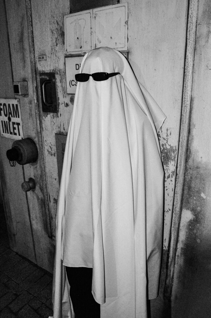 Person dressed as a ghost with sunglasses on