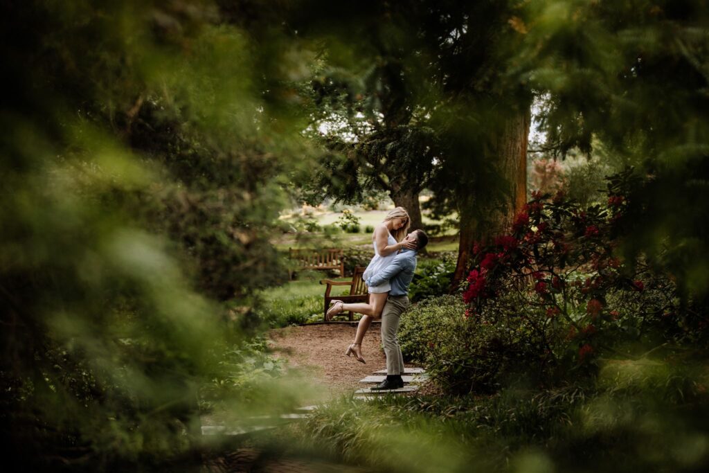 Man holding a woman up in garden